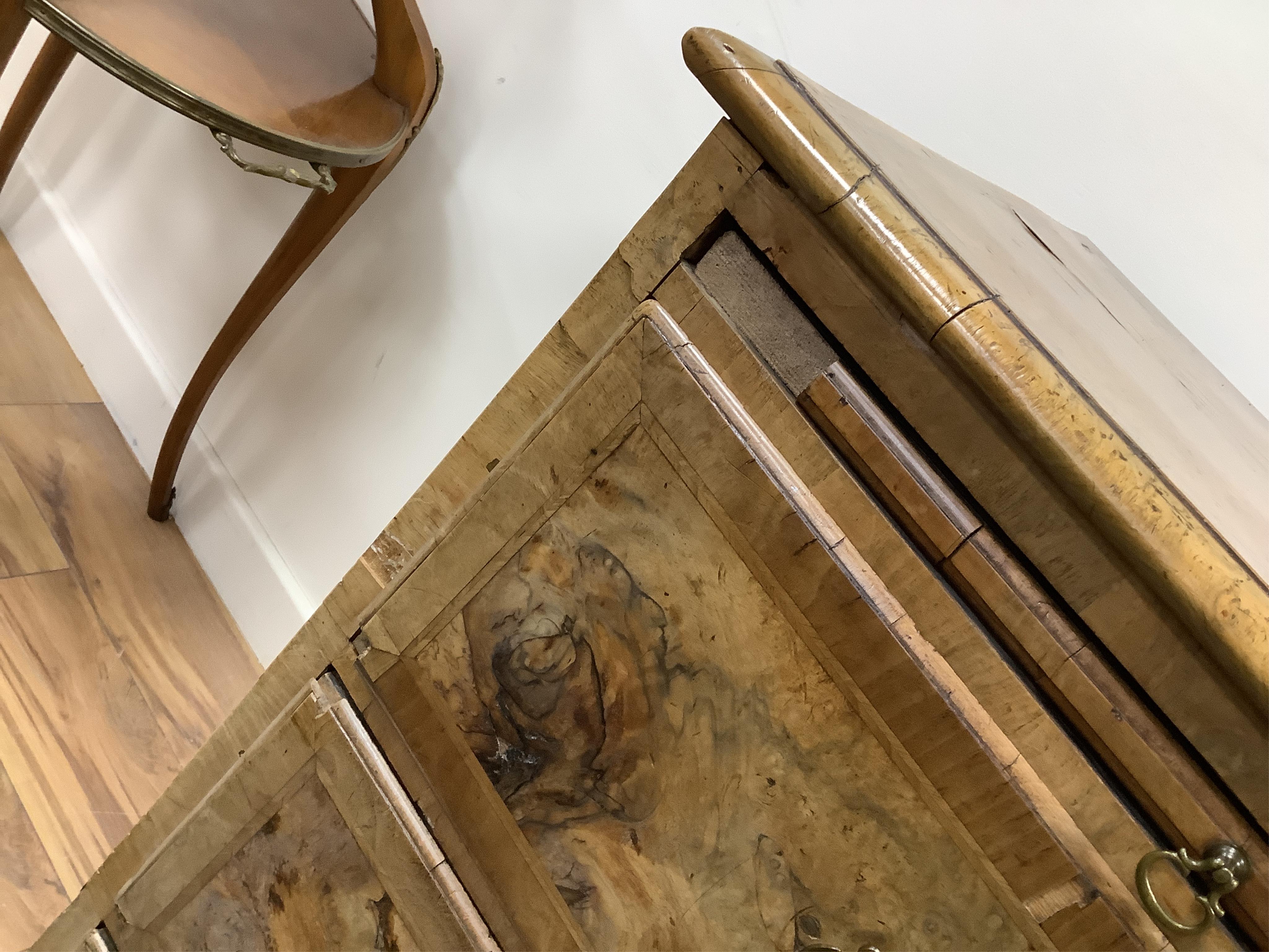 A mid 18th century feather banded walnut concave starburst walnut chest of three drawers, with brushing slide, width 108cm, depth 54cm, height 92cm